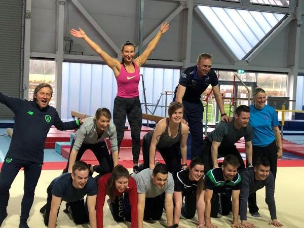adults in a pyramid for adults gymnastics