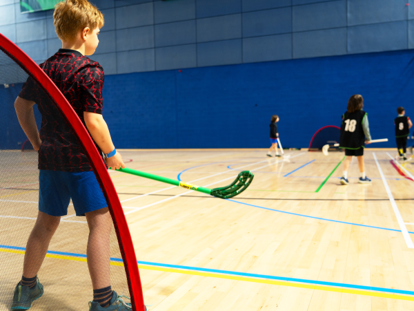 kid playing hockey teen camp