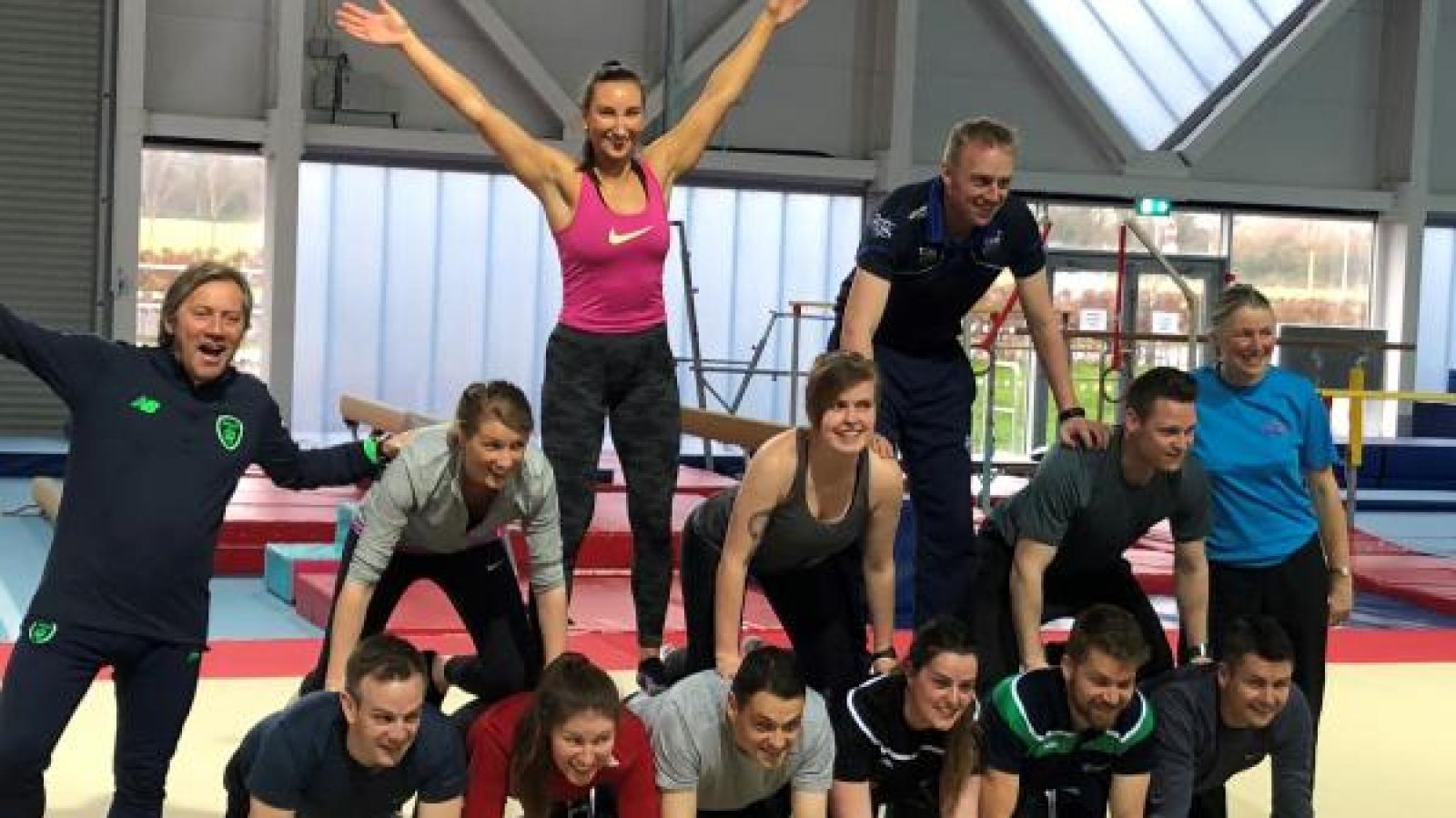 adults in a pyramid for adults gymnastics